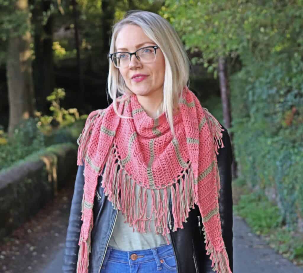 slmon color crochet shawl on woman in woods