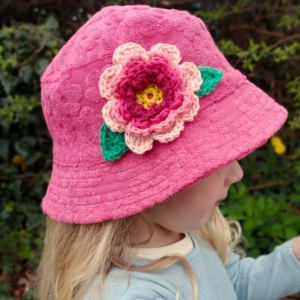 large crochet flower on a childs hat