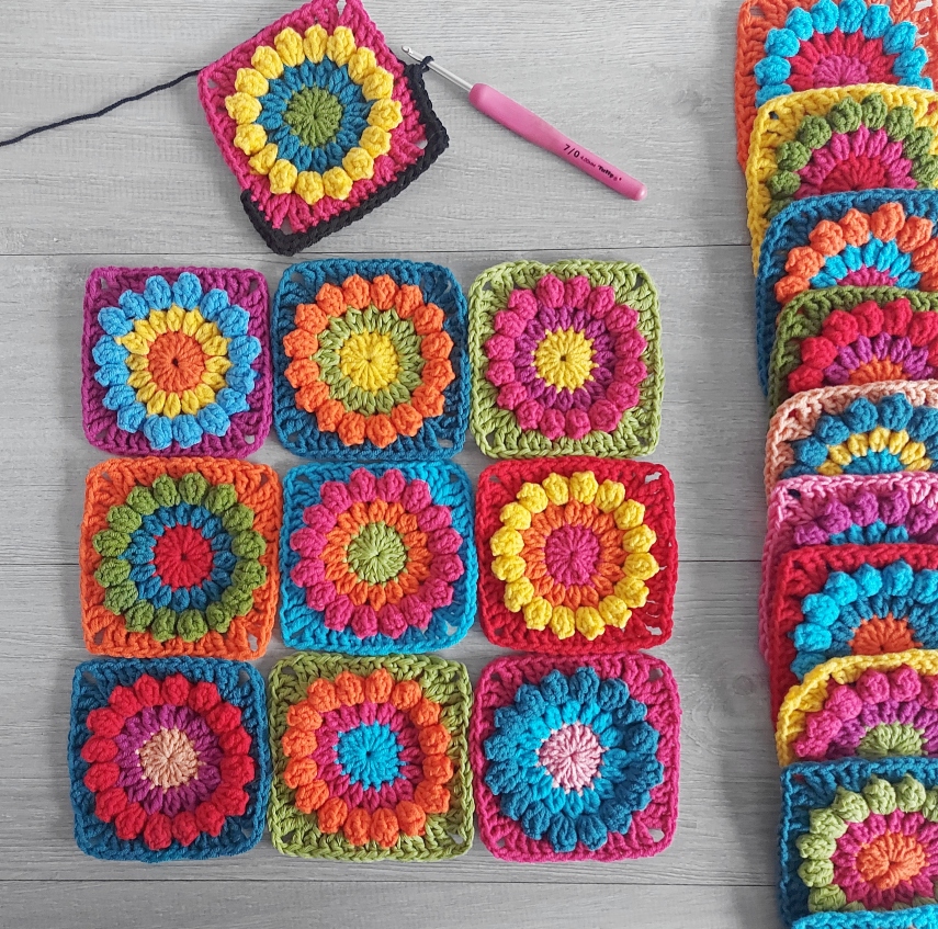 crochet colorful granny squares on a table