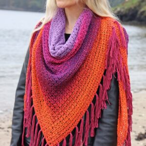 orange and purple crochet shawl around a womans neck