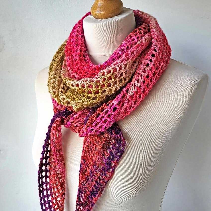crochet neckerchief scarf tied loosely on a mannequin