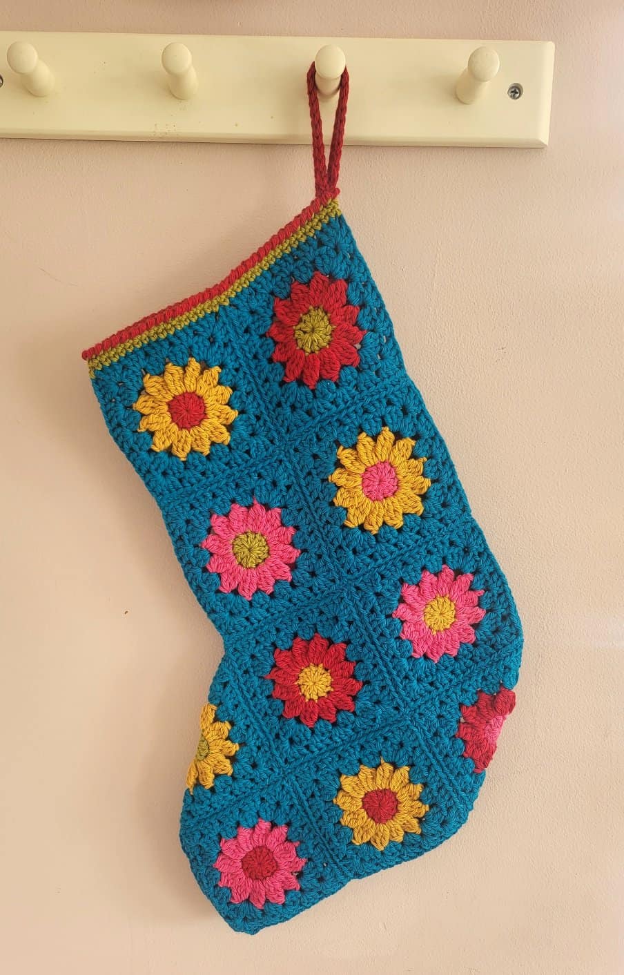 Merry Star Crochet Christmas Stocking hanging on a rack