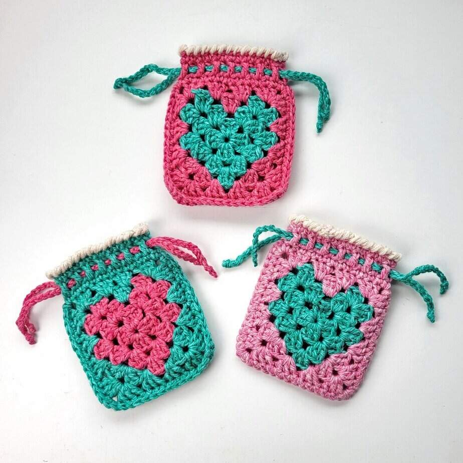 3 crochet bags with a granny heart in pinks and green