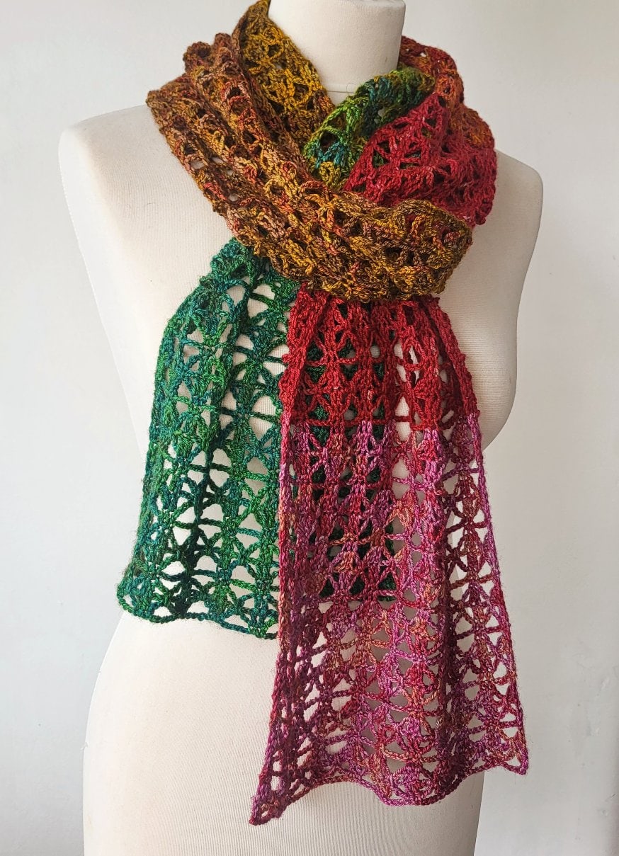 Bláithín - a crochet lacy scarf pattern displayed wrapped around a mannequin