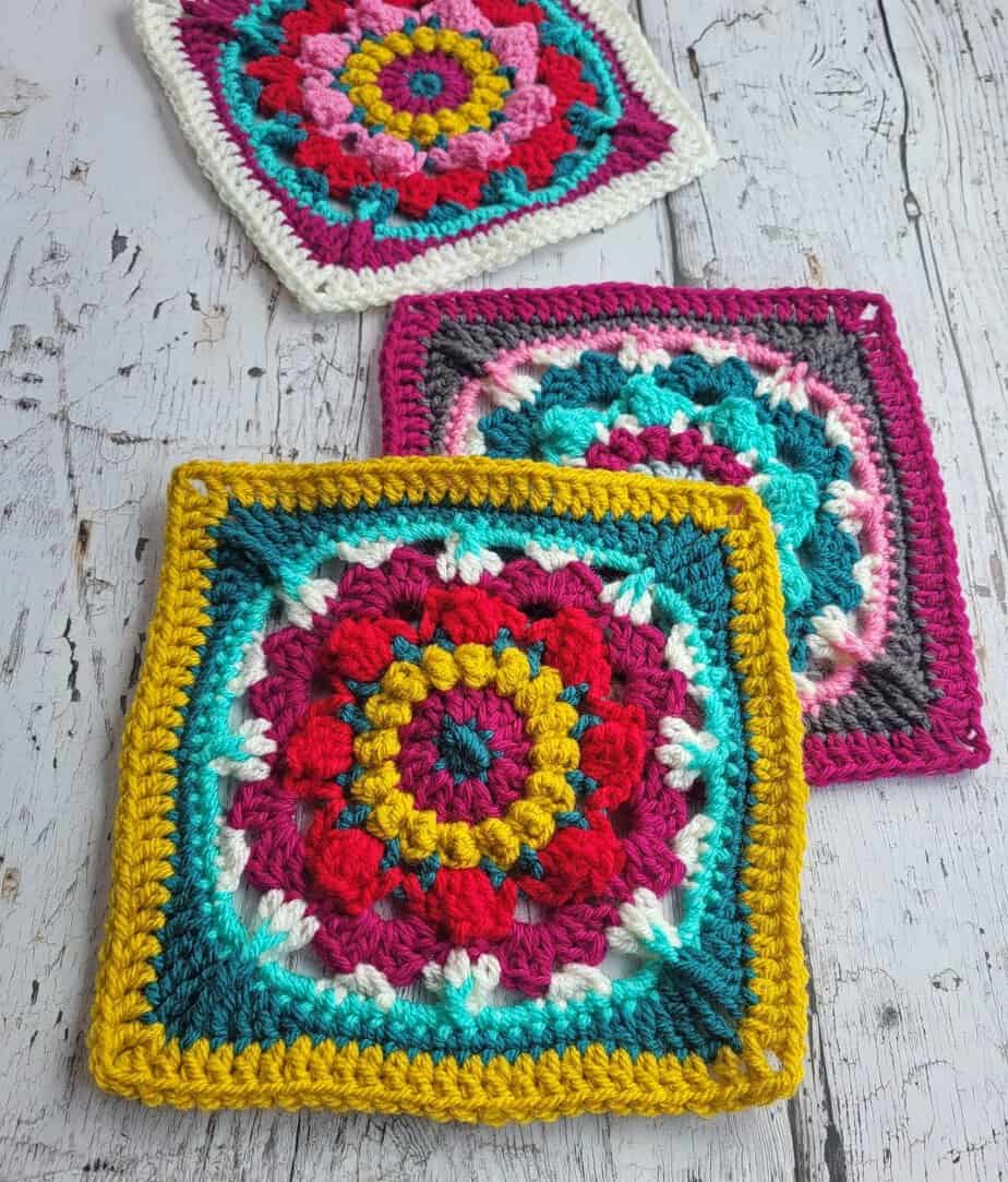 textured granny squares using scarp yarn on a weathered background