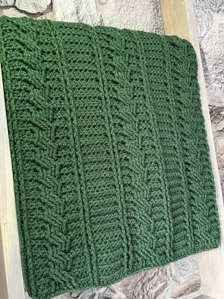 green crochet blanket with cables