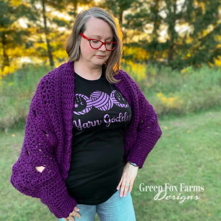 woman wearing a purple crochet cardigan
