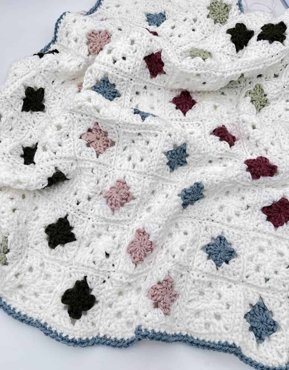 small granny squares on a cream blanket