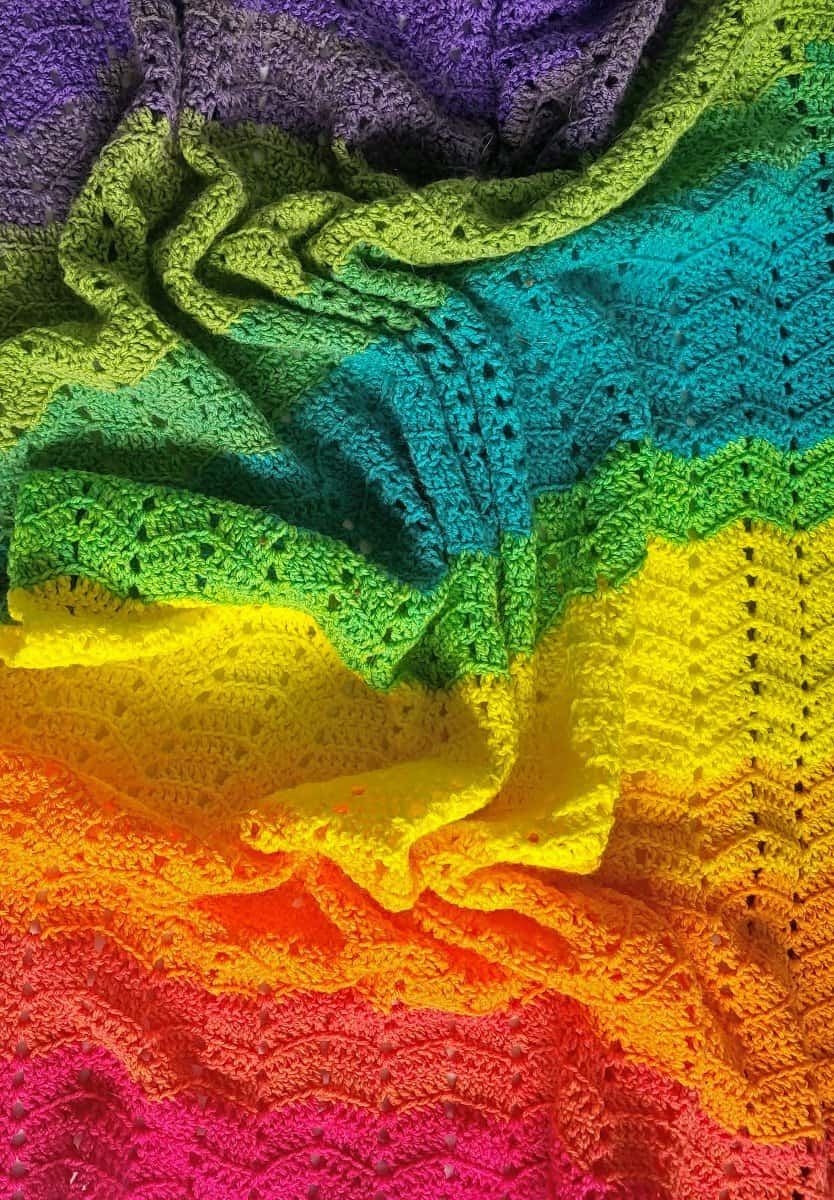 Closeup view of the brightly colored Double Crochet Ripple Blanket, scrunched up to show the texture