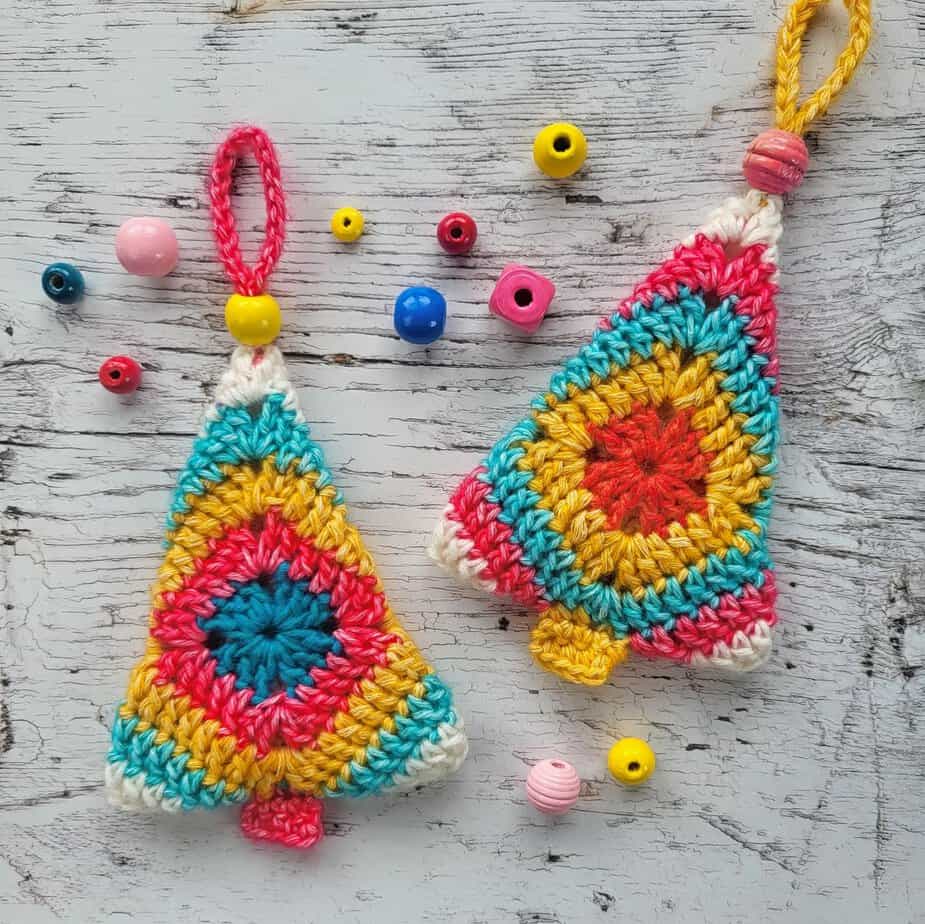 Two granny square Christmas trees, surrounded by colorful beads